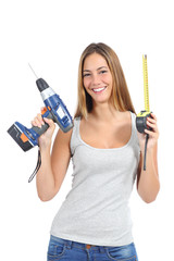 Beautiful woman holding a power drill and a tape measure