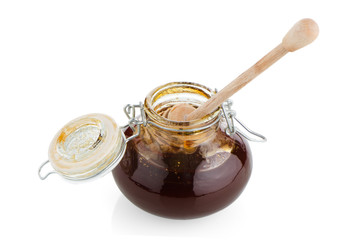 Jar of honey with wooden drizzler