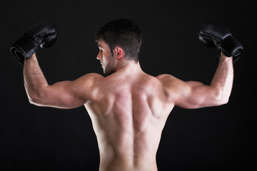Fototapeta na wymiar Portrait sportsman boxer in studio dark background