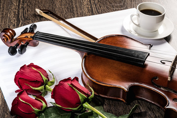Fototapeta premium Violin, rose, glass of champagne and music books