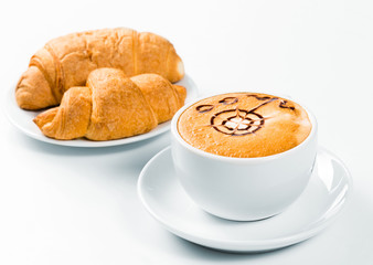 large cup of coffee and croissants on a plate