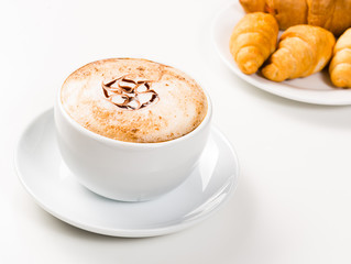 large cup of coffee and croissants on a plate