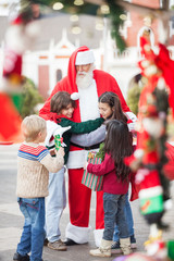 Children Embracing Santa Claus