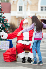 Girl About To Embrace Santa Claus