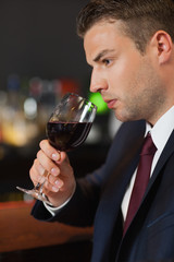Businessman tasting red wine