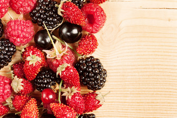 Ripe Berries on Wooden Background
