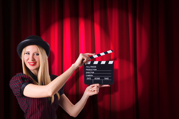 Woman gangster with movie clapper