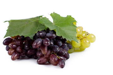 Bunches of red and green grapes with leaves