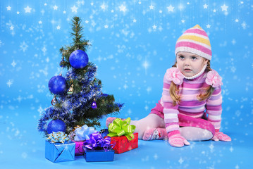 the little girl with the Christmas tree and gifts