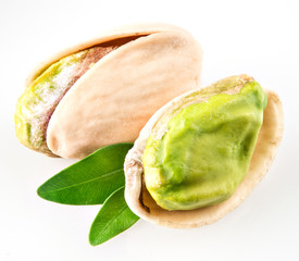 Pistachio nuts with leaf isolated on white