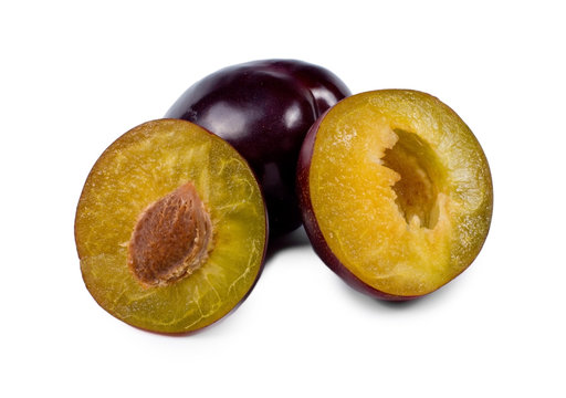 Two halves of a fresh purple plum