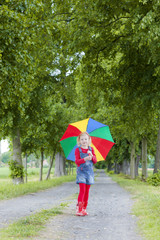 little girl with umbrella in alley