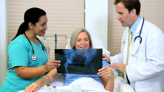 Radiologist Discussing X-Ray Film with Patient