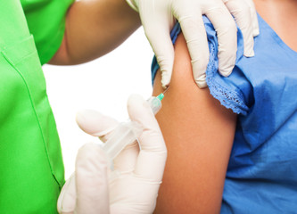 nurse injecting to a girl on a white background