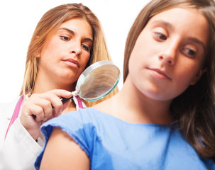 doctor checking a mole on a white background