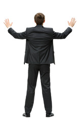 Full-length backview of businessman with hands up