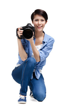 Lady-photographer takes pictures, isolated on white