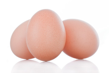 Three brown chicken eggs isolated on white background