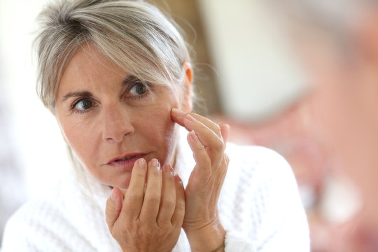 Senior Woman Applying Anti-wrinkles Cream