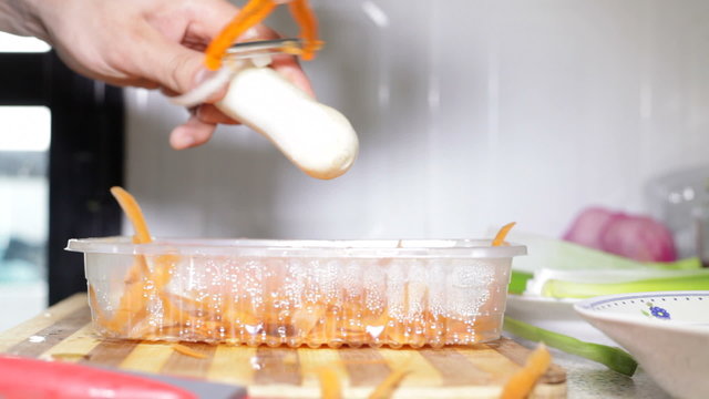 Closeup of hands peeling root vegetable