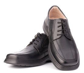 Black glossy man’s shoes with shoelaces