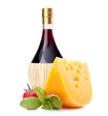 Red wine bottle, cheese and tomato still life