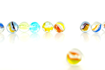Colourful marbles on white background