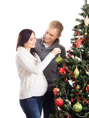 A happy couple waiting for the baby and celebrating Christmas