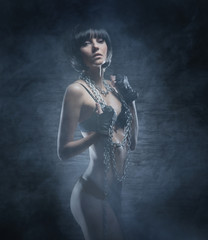 Fashion shoot of a young woman posing in a fetish dress