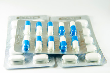 Blue and white capsule in blister pack