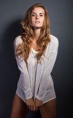 Fototapeta premium Sexy woman in long sleeve white t-shirt covering panties