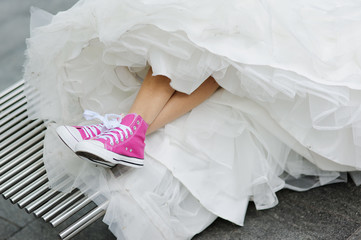 Pink gym shoes and a wedding dress