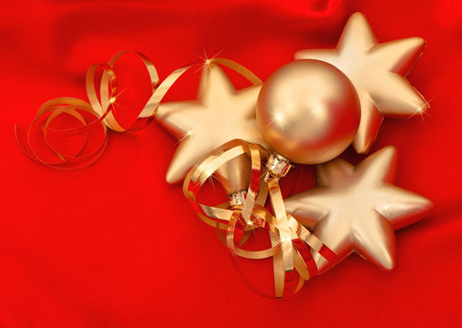 golden christmas baubles over red silk background