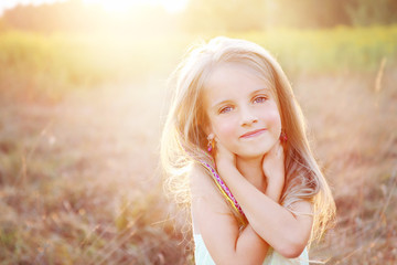 Happy little girl on summer meadow