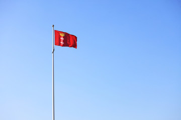 Flag city of Gdansk Danzig in the sky background Poland