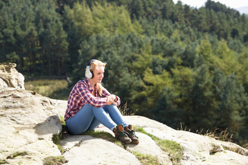 Naklejka na ściany i meble Teenage Girl Listening To Music In Countryside