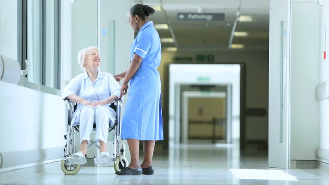 Wheelchair Patient Receiving Care Medical Staff
