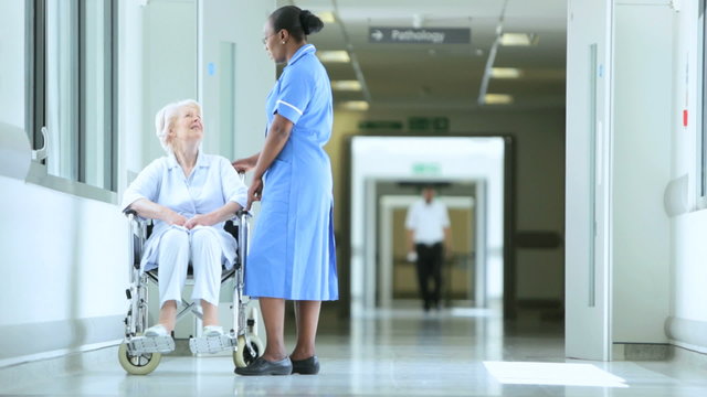 Hospital Corridor Ethnic Nurse Wheelchair Patient