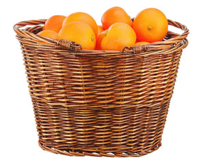 Oranges in wicker basket isolated on white.