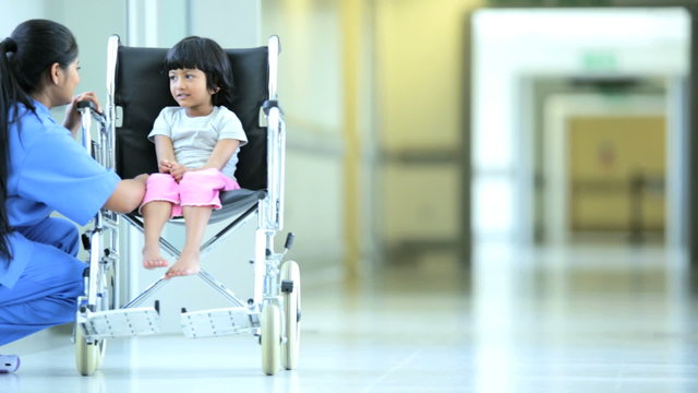 Asian Indian Nurse Talking Little Ethnic Girl Hospital Wheelchair