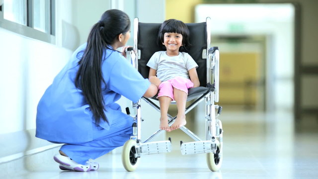 Asian Indian Nurse Talking Little Ethnic Girl Hospital Wheelchair