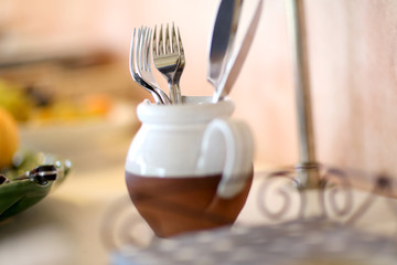 Silverware set in pot on table