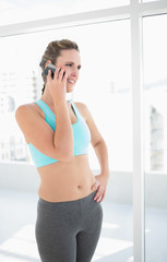 Fit woman in sportswear talking on the phone