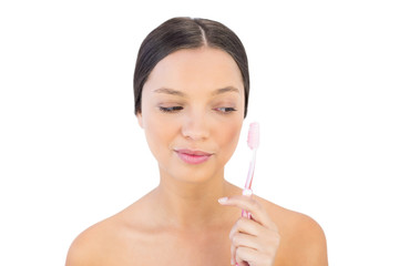 Obraz na płótnie Canvas Brunette woman looking at her teeth brush