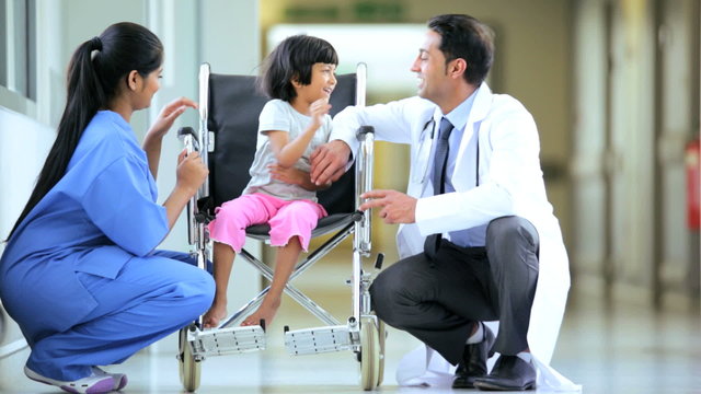 Ethnic Doctor Nurse Reassuring Young Child Patient