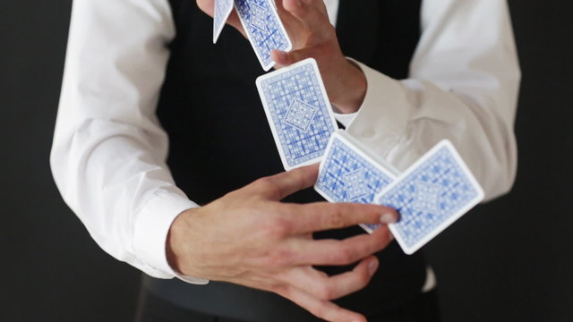 man showing trick with playing cards