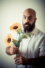 long beard and mustache man giving flowers