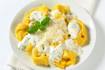 Ricotta and spinach tortelloni with cream sauce and Parmesan