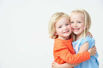 Two Pre School Girls Hugging One Another