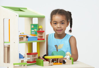 Pre-School Pupil Playing With Wooden House